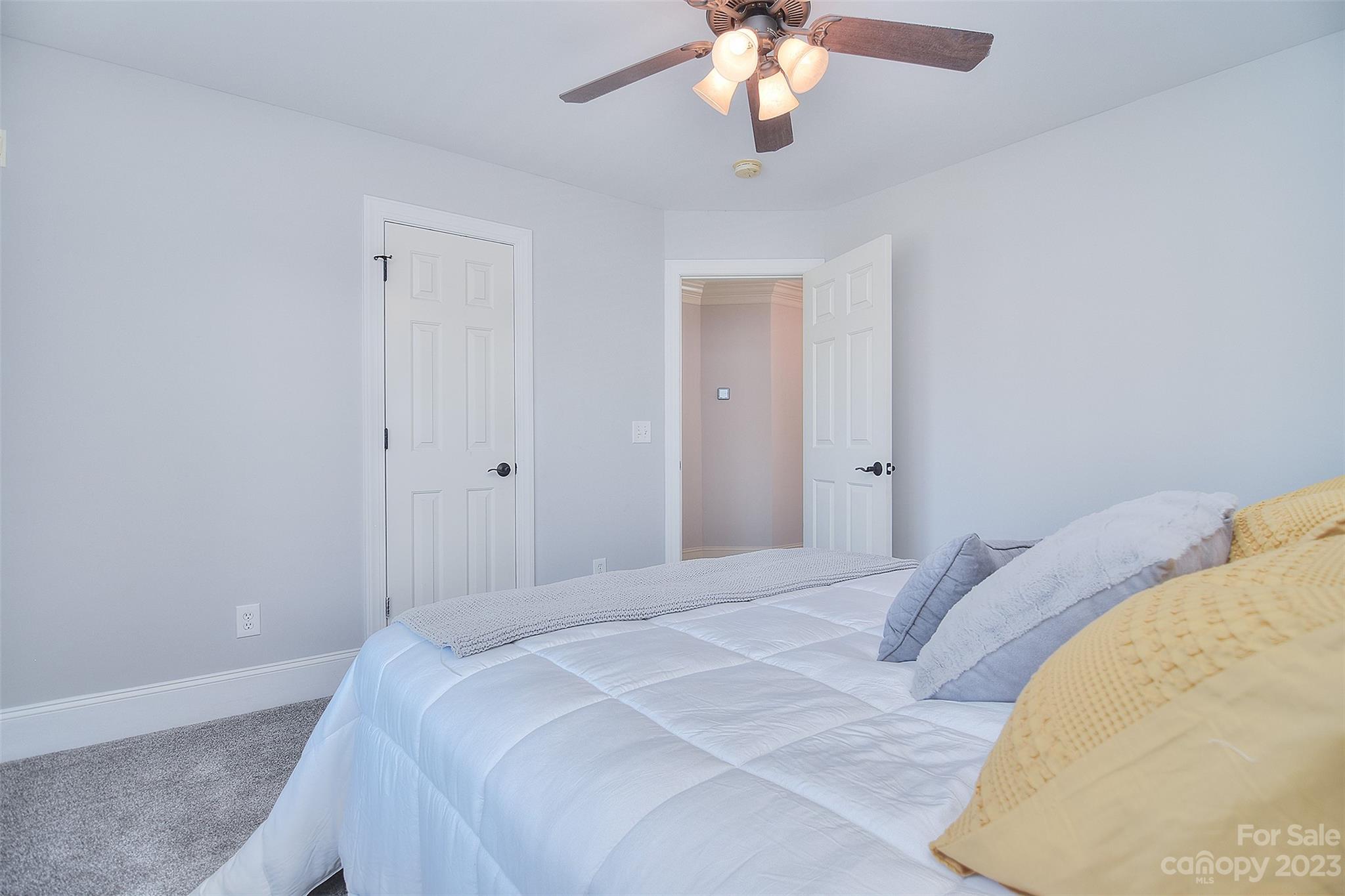 4913 Campobello Drive Monroe, NC 28110 - Photo 28 of 46 a bedroom with a bed and a chandelier