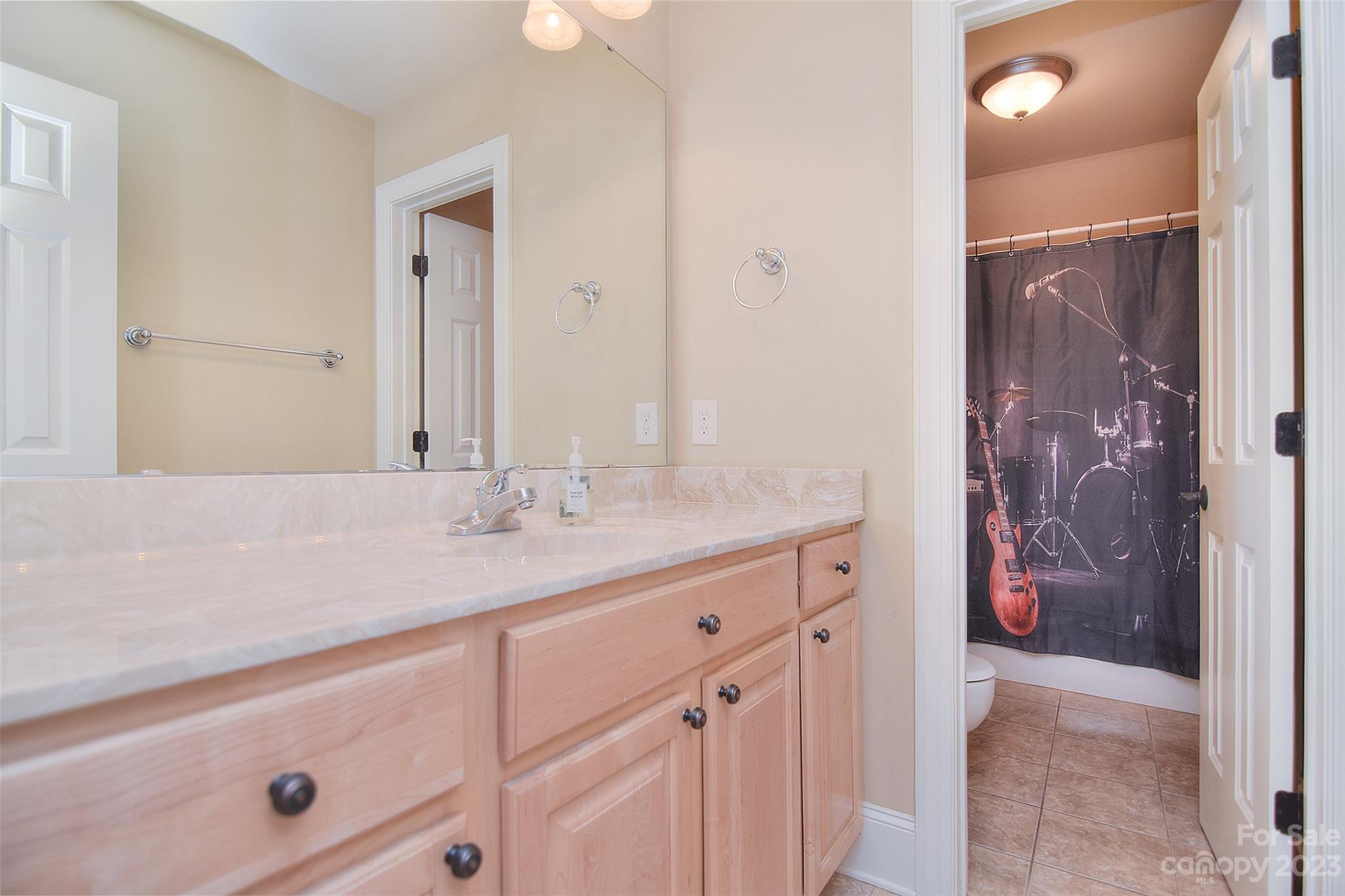 4913 Campobello Drive Monroe, NC 28110 - Photo 30 of 46 a bathroom with a granite countertop sink and a mirror