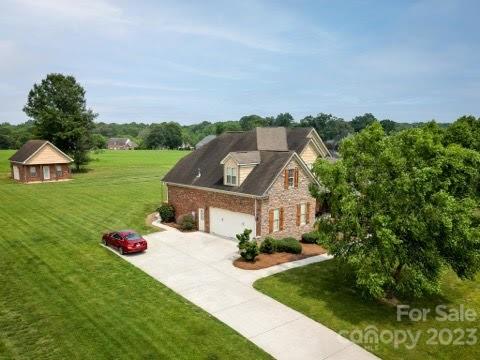 4913 Campobello Drive Monroe, NC 28110 - Photo 44 of 46 a front view of a house with garden