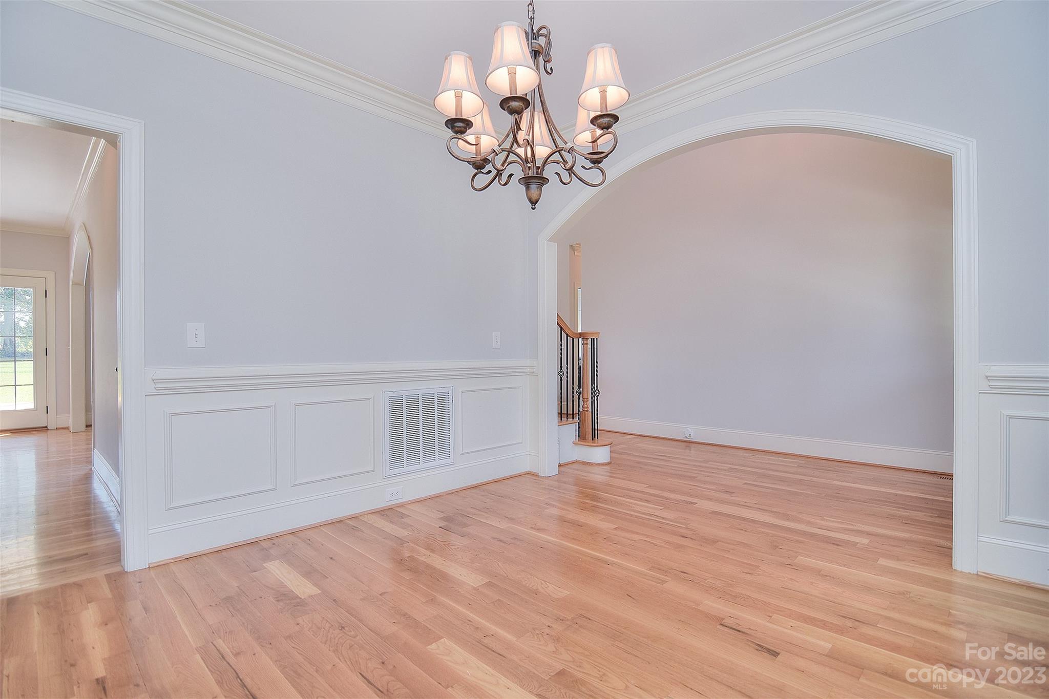 4913 Campobello Drive Monroe, NC 28110 - Photo 5 of 46 a view of empty room with wooden floor and chandelier