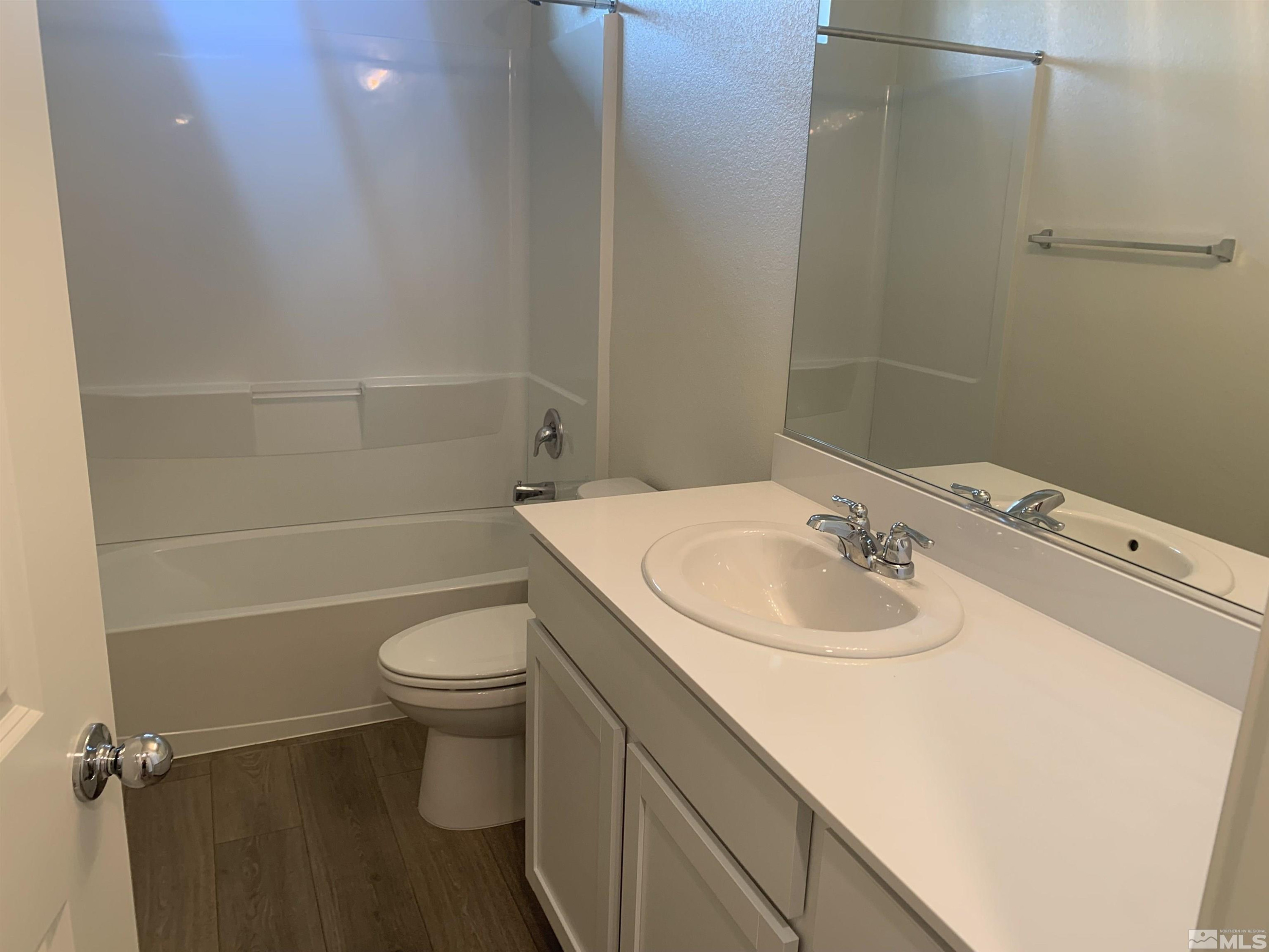8839 Wolf Moon Drive Reno, NV 89506 - Photo 12 of 15 a bathroom with a sink toilet vanity and shower