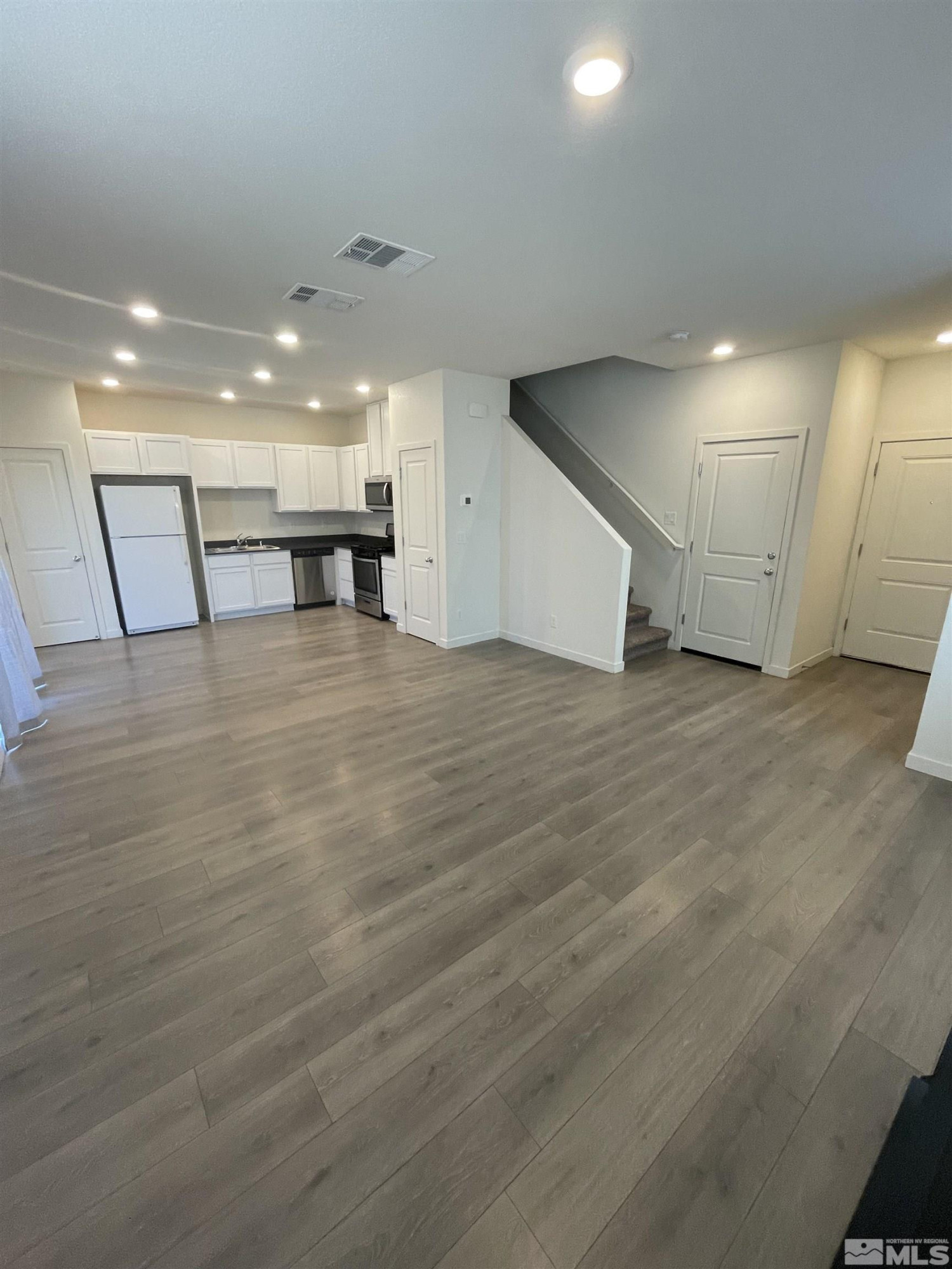 8839 Wolf Moon Drive Reno, NV 89506 - Photo 6 of 15 a view of an empty room with wooden floor