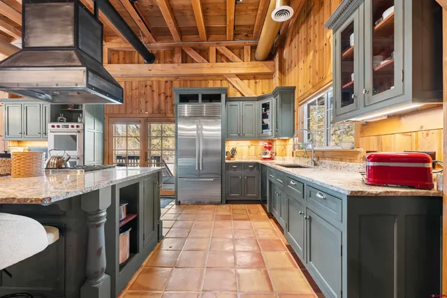 a kitchen with stainless steel appliances granite countertop a stove and cabinets