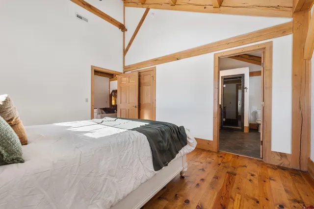 a bedroom with a bed and a mirror