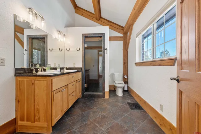 a large bathroom with a double vanity sink a mirror and a bathtub