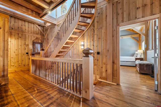 a view of entryway with wooden floor and a front door