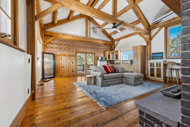 a living room with furniture and a floor to ceiling window