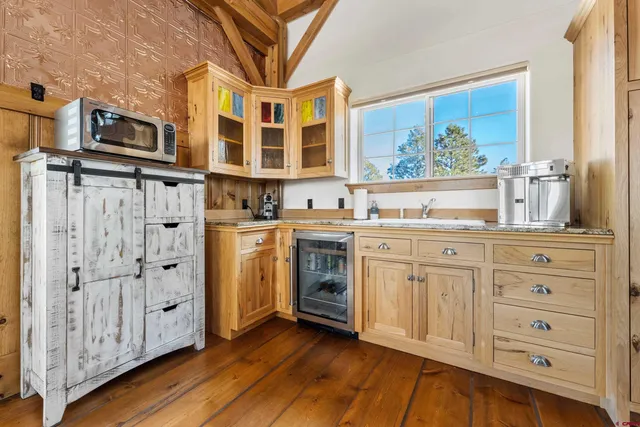 a view of a kitchen with cabinets and wooden floor