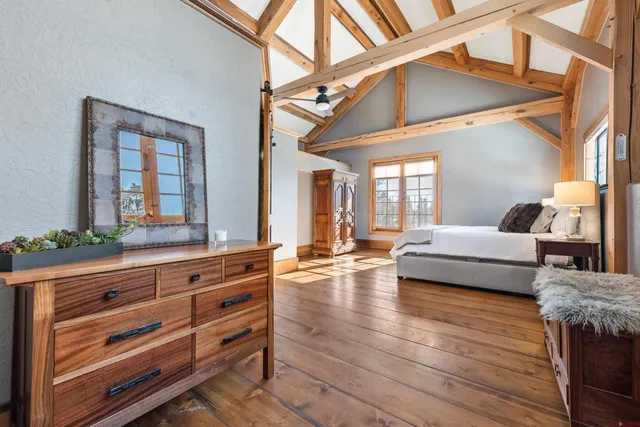 a spacious bedroom with a bed and a large mirror