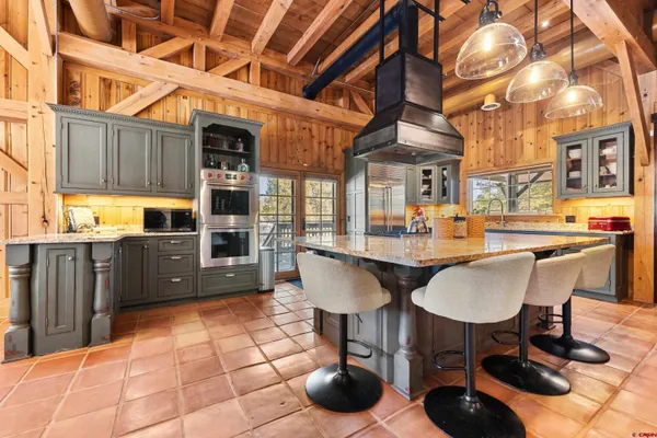 a front view of a house with a yard and tree s