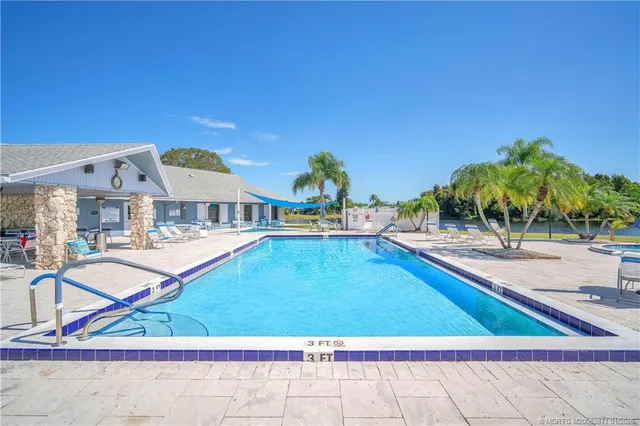 a view of a swimming pool with an outdoor seating