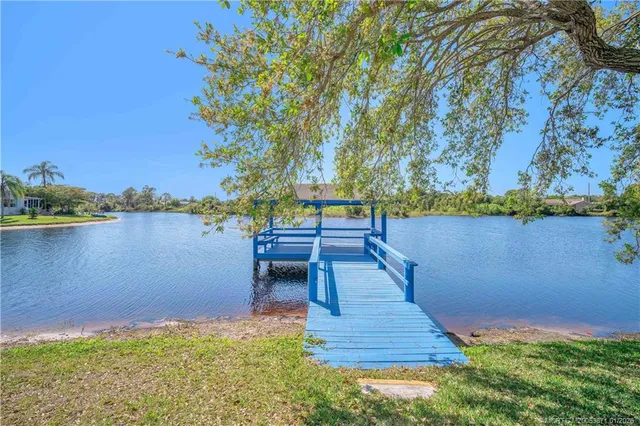 a view of a lake with a bench next to a lake