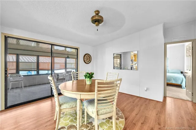 a dining room with furniture a window and wooden floor