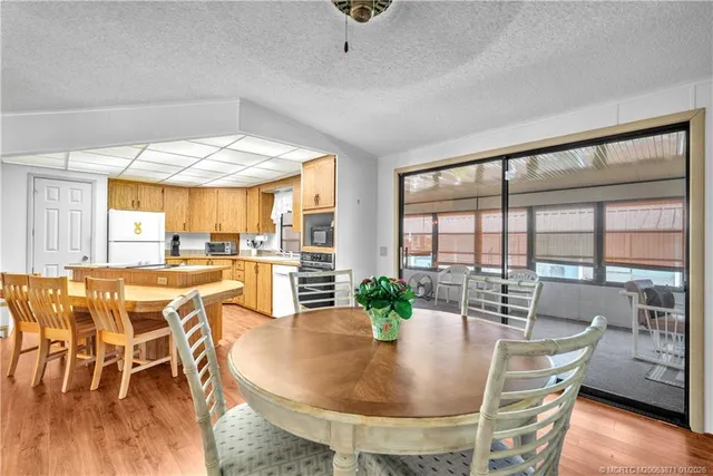 a dining room with furniture window and wooden floor