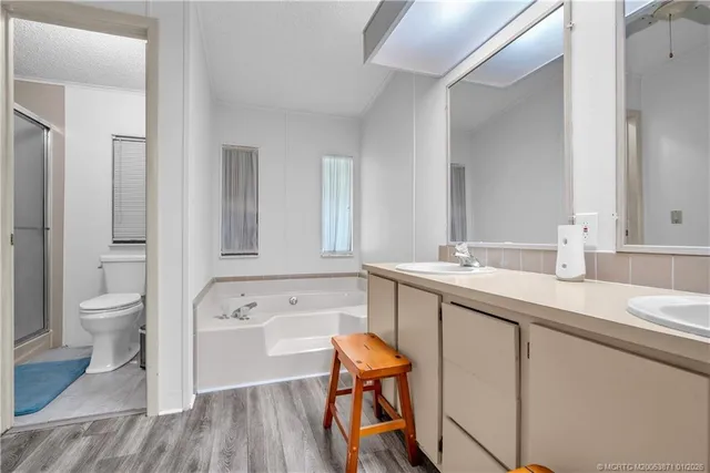 a spacious bathroom with a bathtub shower sink and toilet