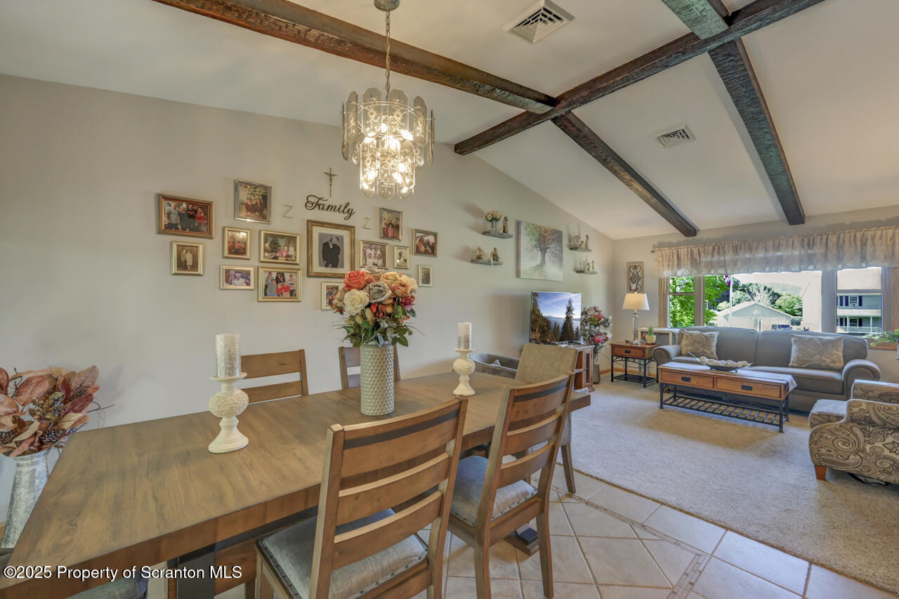 143 Beech Road Moscow, PA 18444 - Photo 23 of 89 a dining room with furniture a chandelier and wooden floor