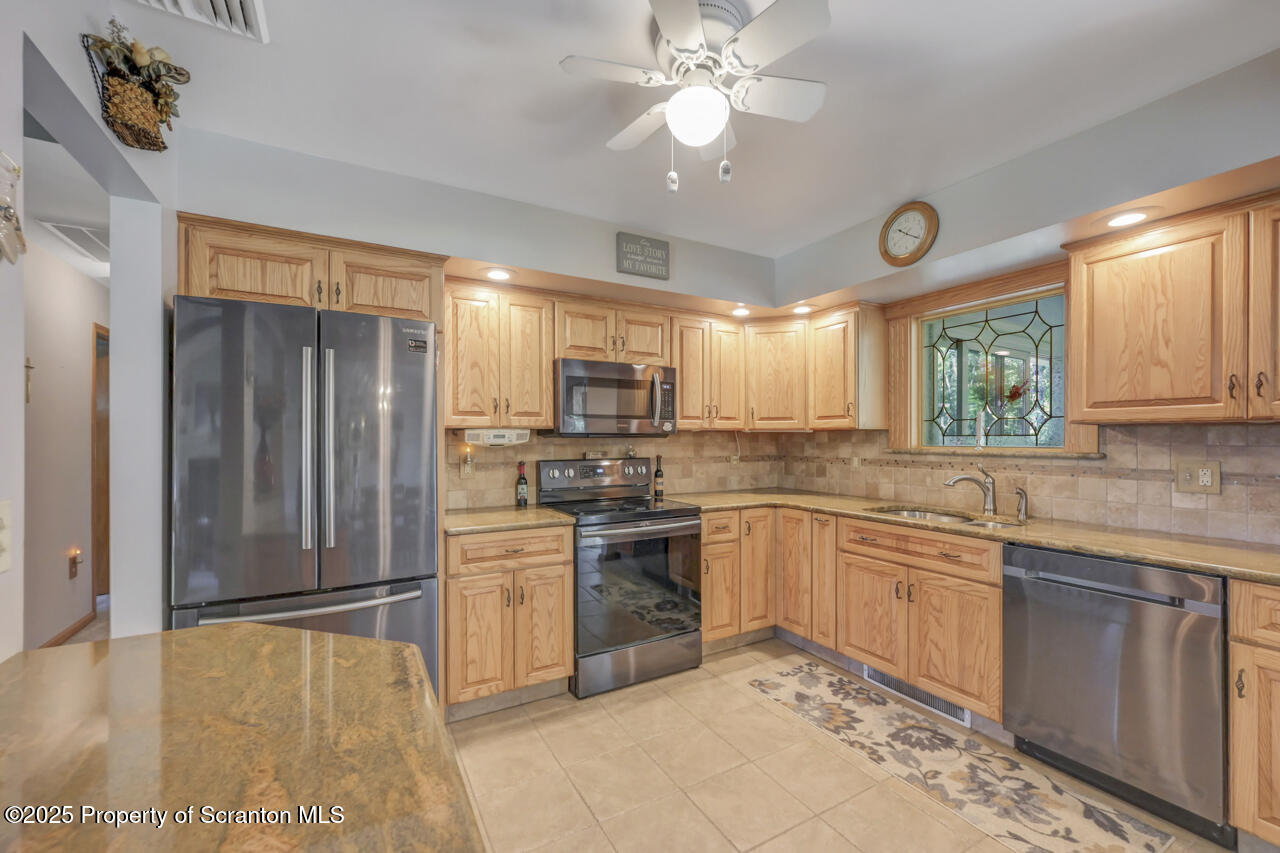 143 Beech Road Moscow, PA 18444 - Photo 28 of 89 a kitchen with stainless steel appliances granite countertop a stove cabinets and refrigerator