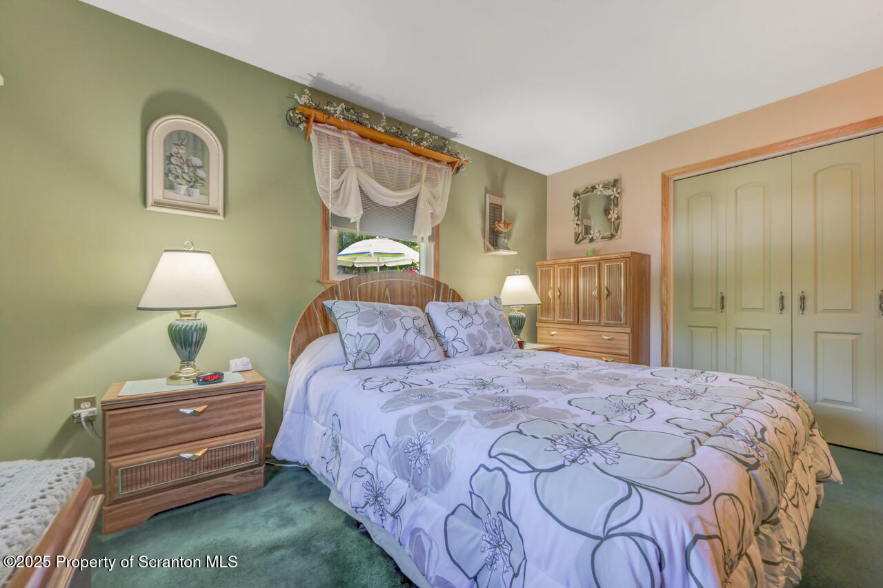 143 Beech Road Moscow, PA 18444 - Photo 39 of 89 a bedroom with a bed and a lamp