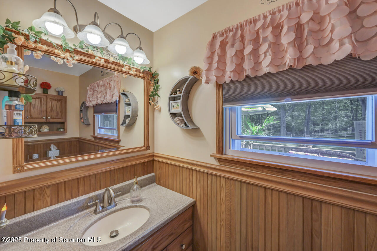 143 Beech Road Moscow, PA 18444 - Photo 41 of 89 a bathroom with a sink a large mirror and a window