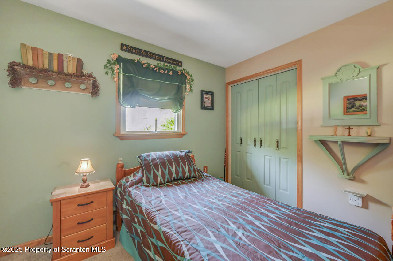 143 Beech Road Moscow, PA 18444 - Photo 47 of 89 a bedroom with a bed and wooden floor
