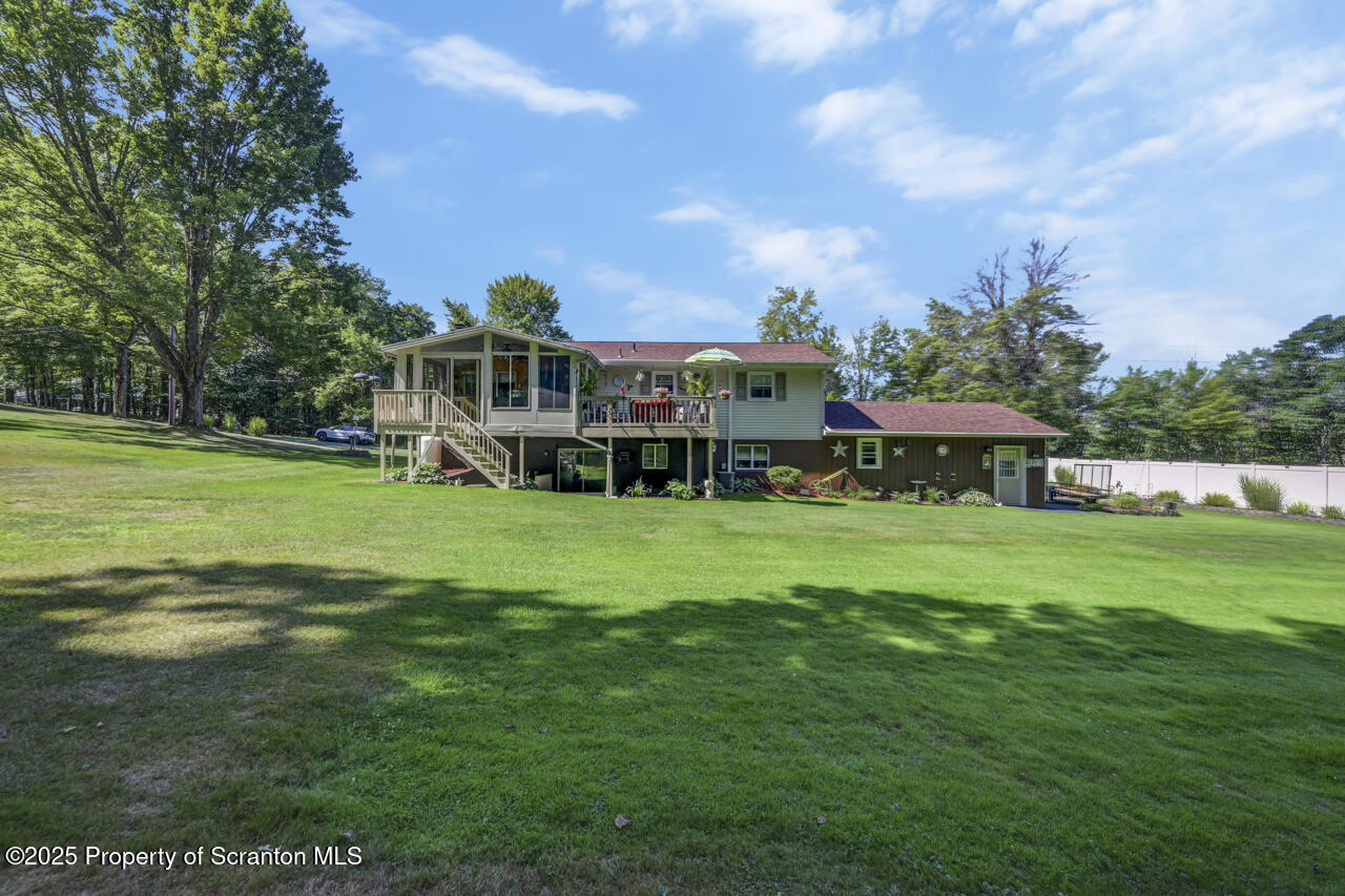 143 Beech Road Moscow, PA 18444 - Photo 76 of 89 a view of a big yard with table and chairs under an umbrella