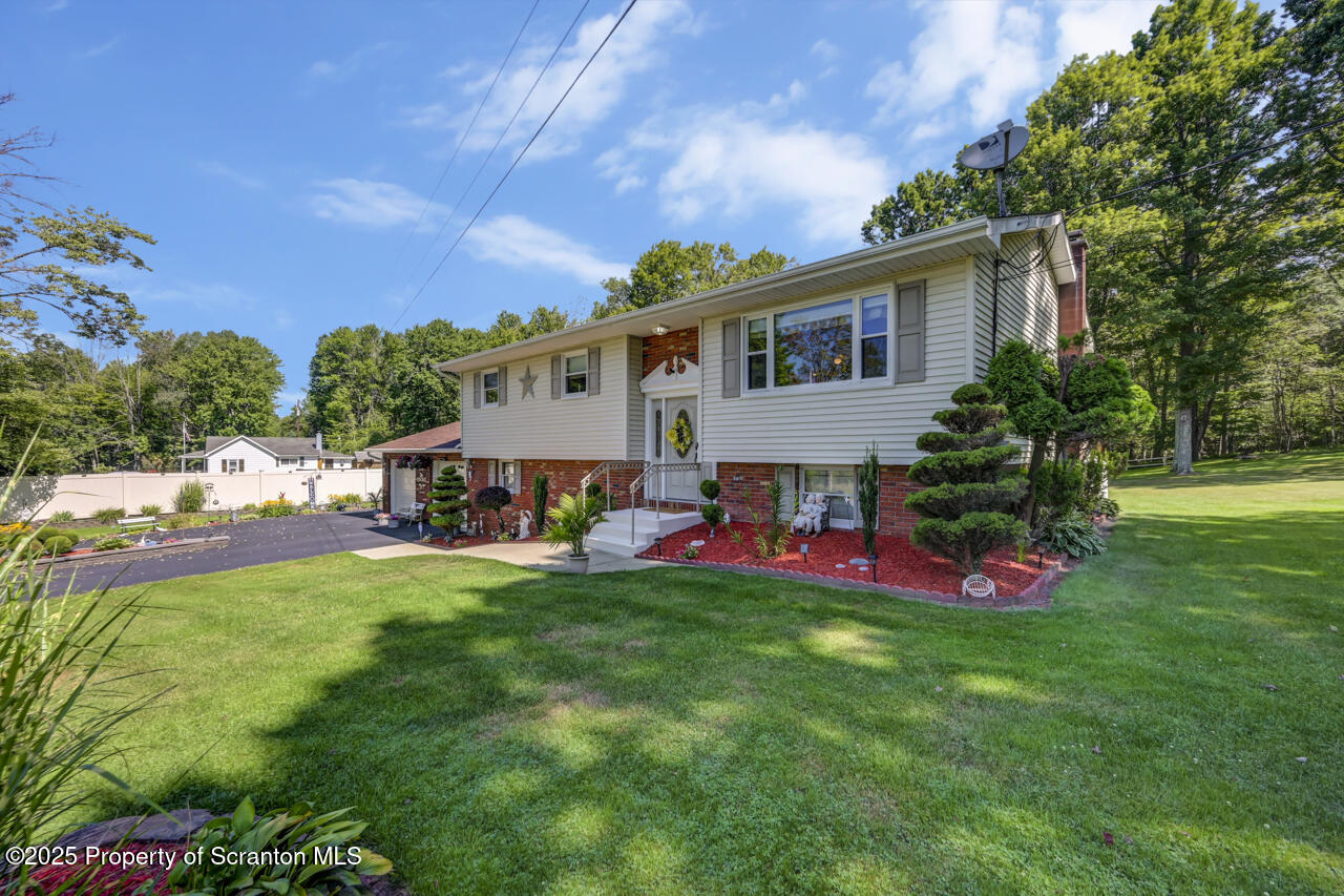 143 Beech Road Moscow, PA 18444 - Photo 8 of 89 a front view of house with yard outdoor seating and green space