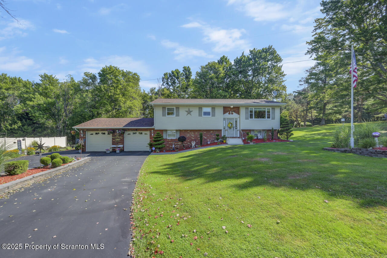 143 Beech Road Moscow, PA 18444 - Photo 88 of 89 a front view of a house with a garden and trees