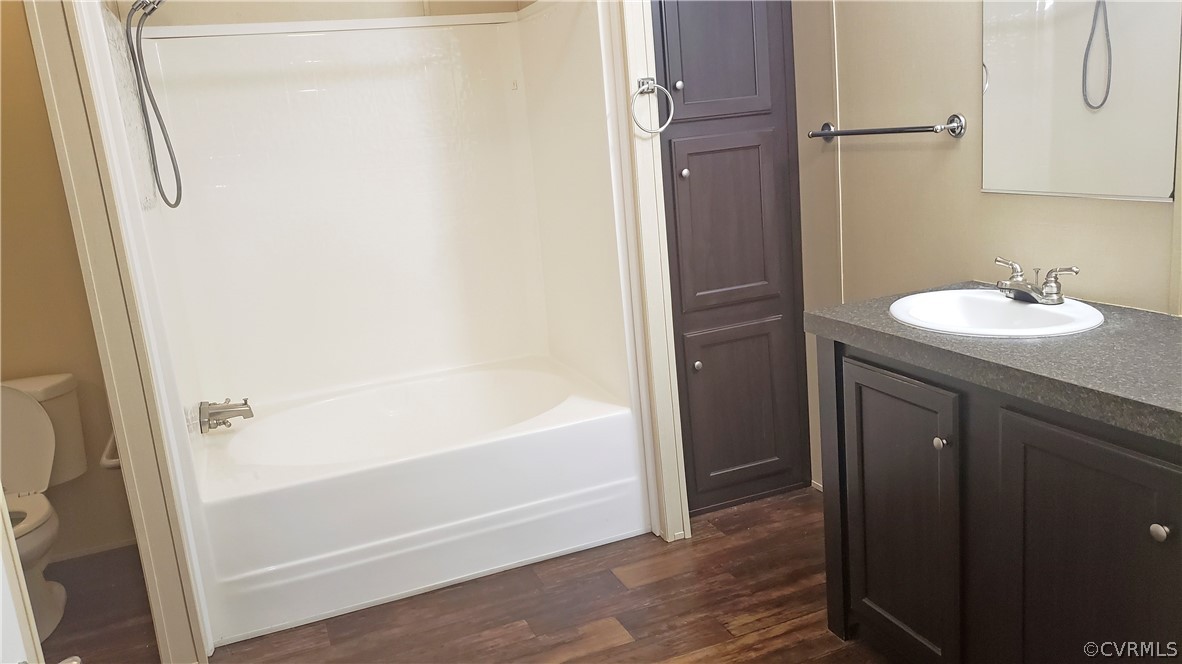 7215 Lunenburg County Road Keysville, VA 23947 - Photo 10 of 16 a bathroom with a granite countertop sink toilet and shower