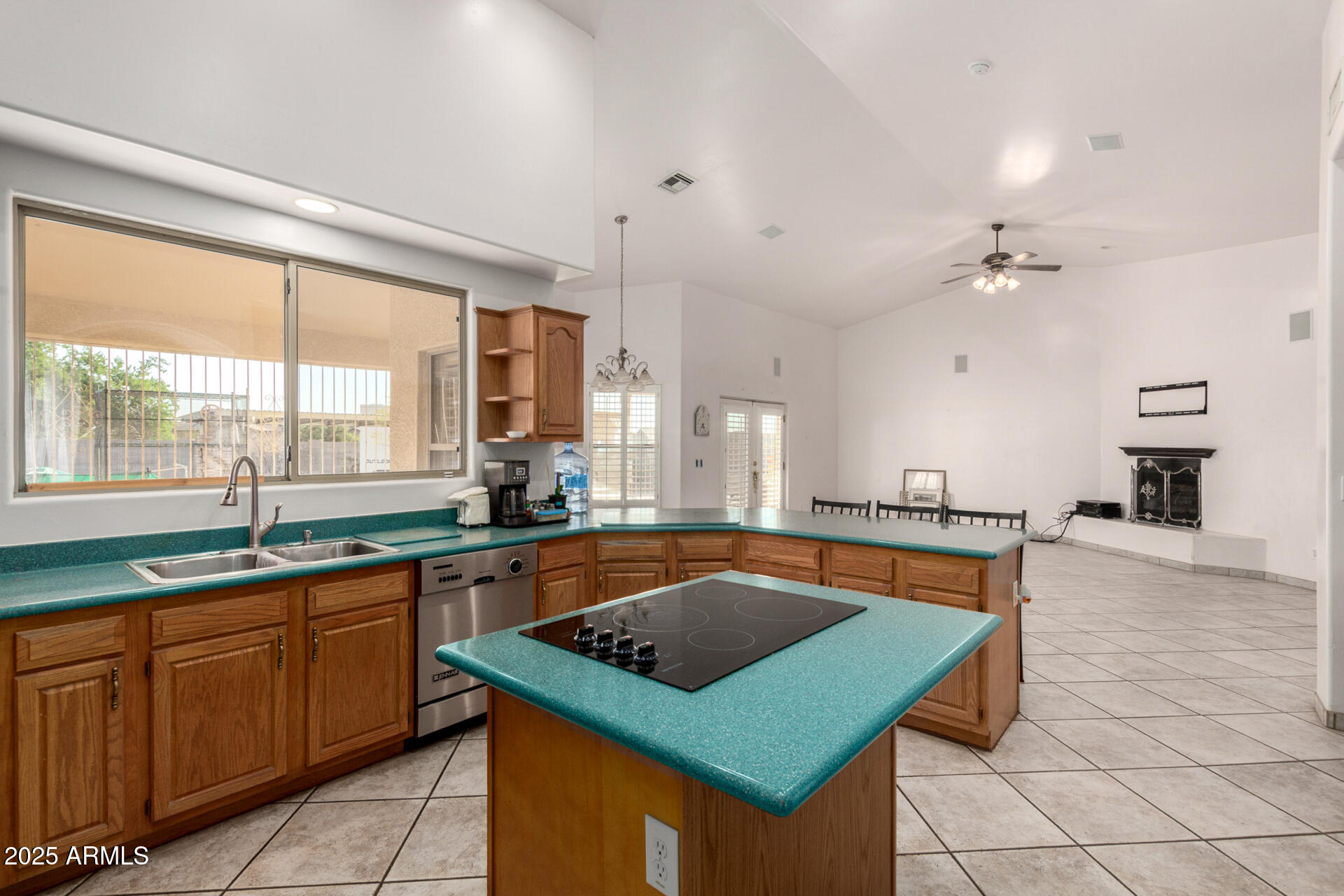 8828 South 16th Street Phoenix, AZ 85042 - Photo 19 of 63 a kitchen with stainless steel appliances granite countertop a sink a stove counter space and a window