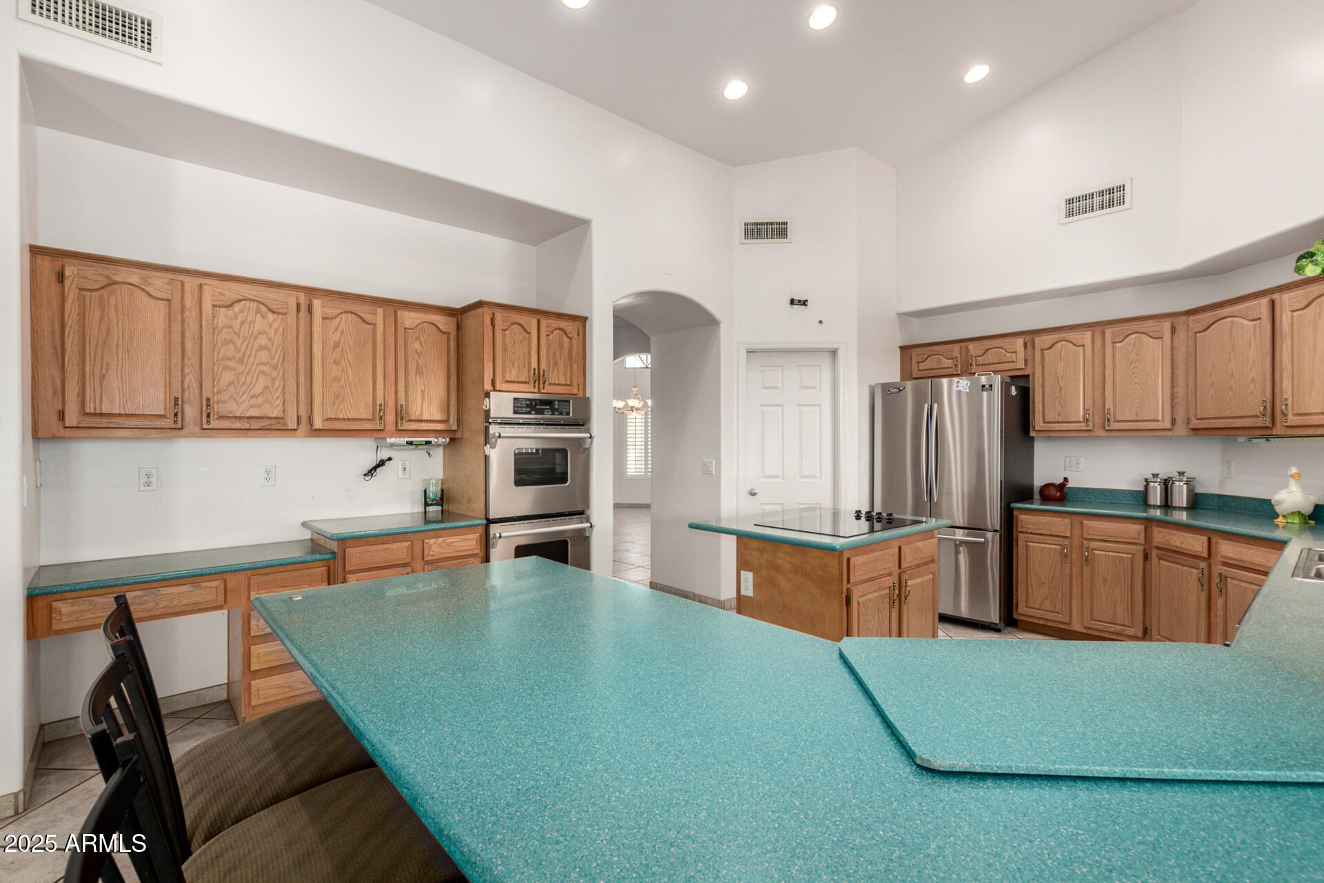 8828 South 16th Street Phoenix, AZ 85042 - Photo 21 of 63 a kitchen with stainless steel appliances granite countertop a refrigerator sink and cabinets