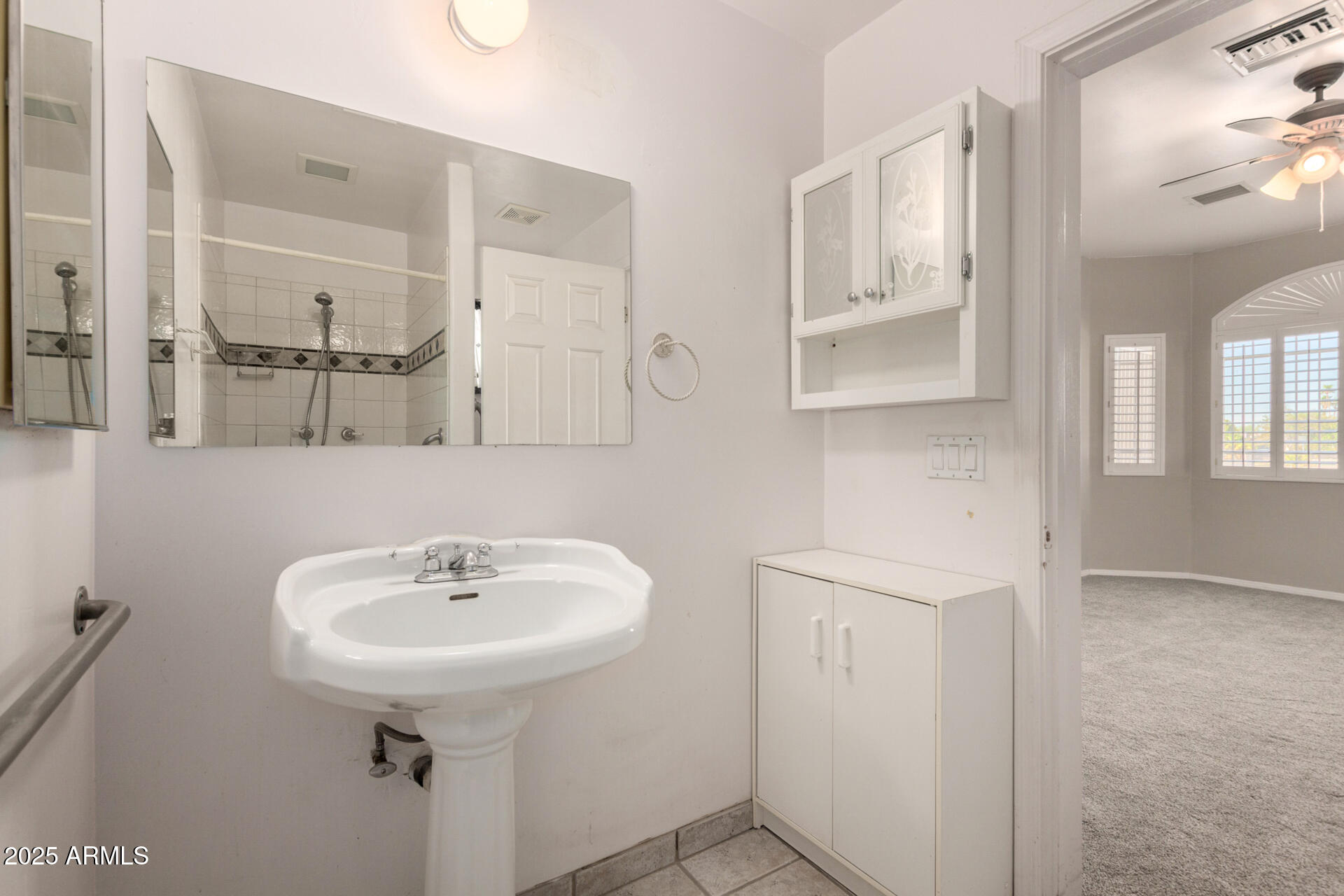 8828 South 16th Street Phoenix, AZ 85042 - Photo 31 of 63 a bathroom with a sink a mirror and shower