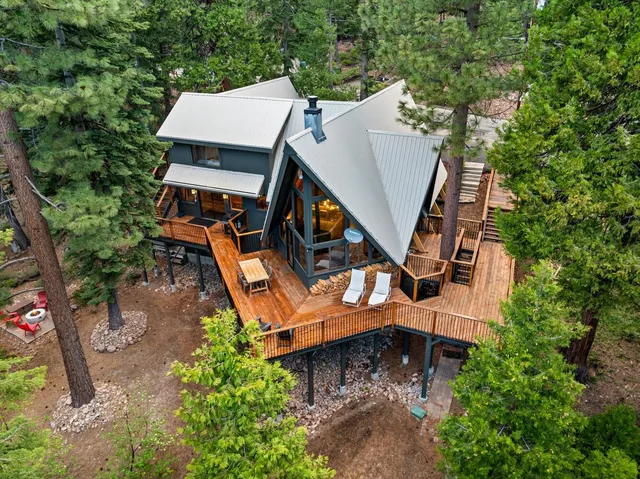 an aerial view of a house with table and chairs