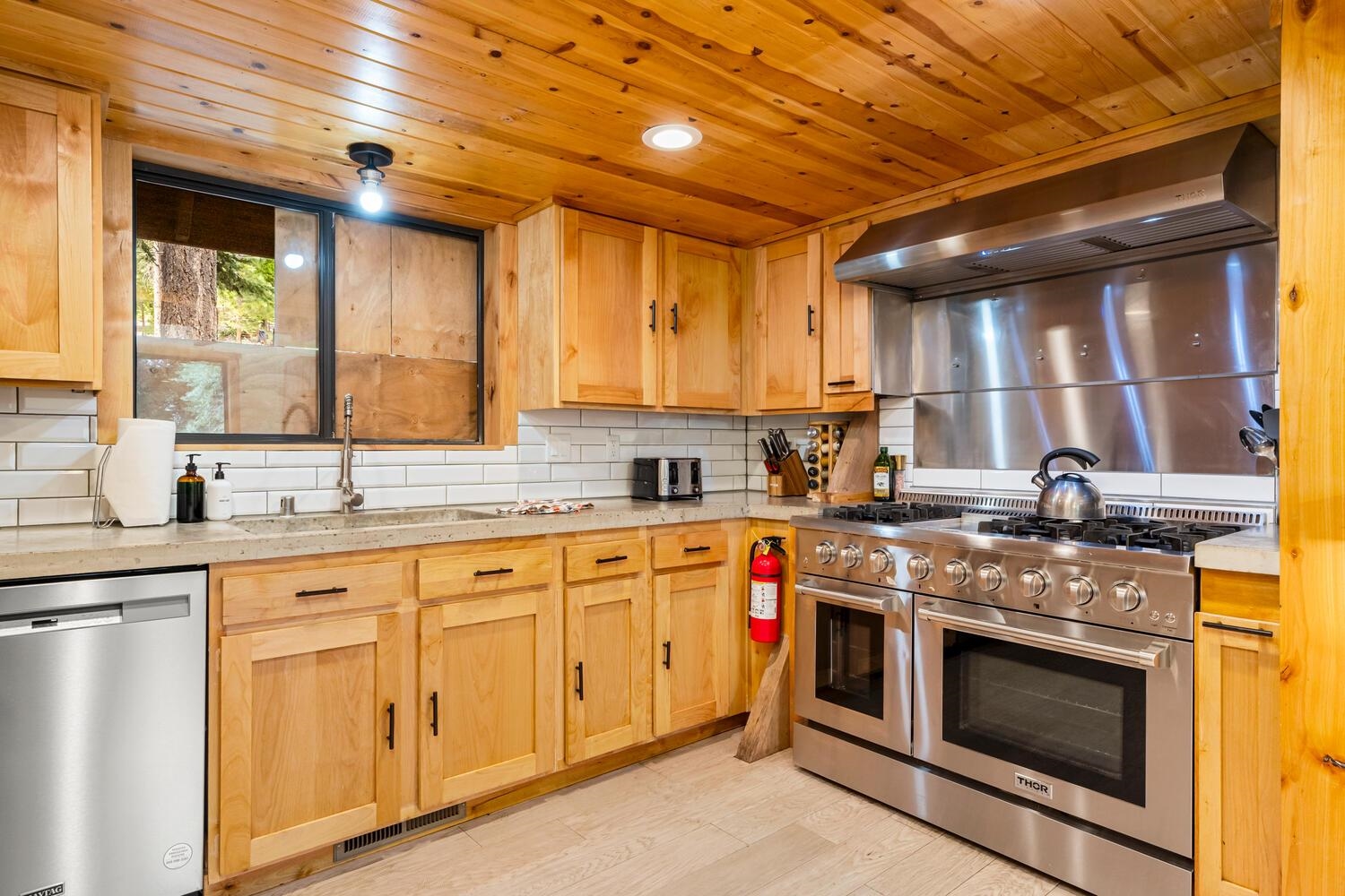 573 Granite Road Carnelian Bay, CA 96140 - Photo 6 of 21 a kitchen with stainless steel appliances granite countertop a stove sink and cabinets
