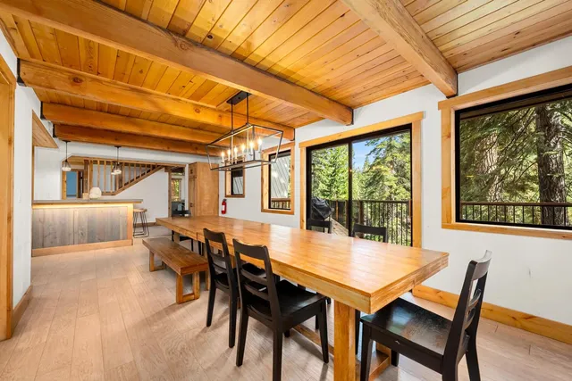 a view of a dining room with furniture large windows and wooden floor