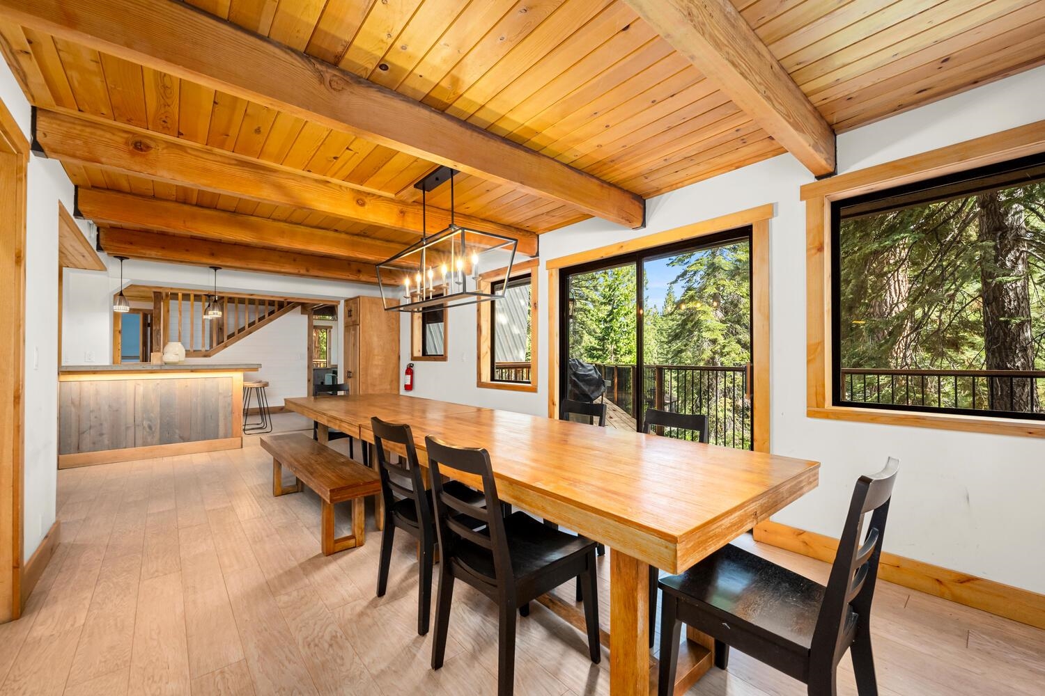 573 Granite Road Carnelian Bay, CA 96140 - Photo 7 of 21 a view of a dining room with furniture large windows and wooden floor