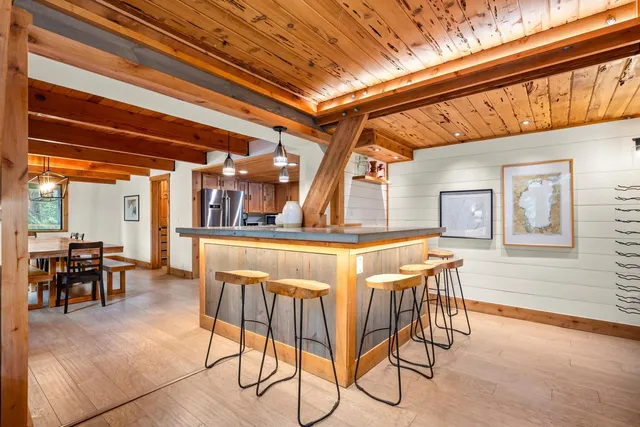 a dining room with furniture and a floor to ceiling window