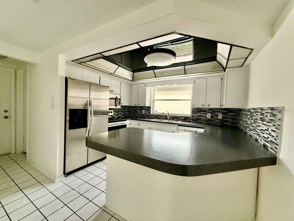 7131 Potomac Drive Port Richey, FL 34668 - Photo 12 of 30 a view of a kitchen with a sink and cabinets