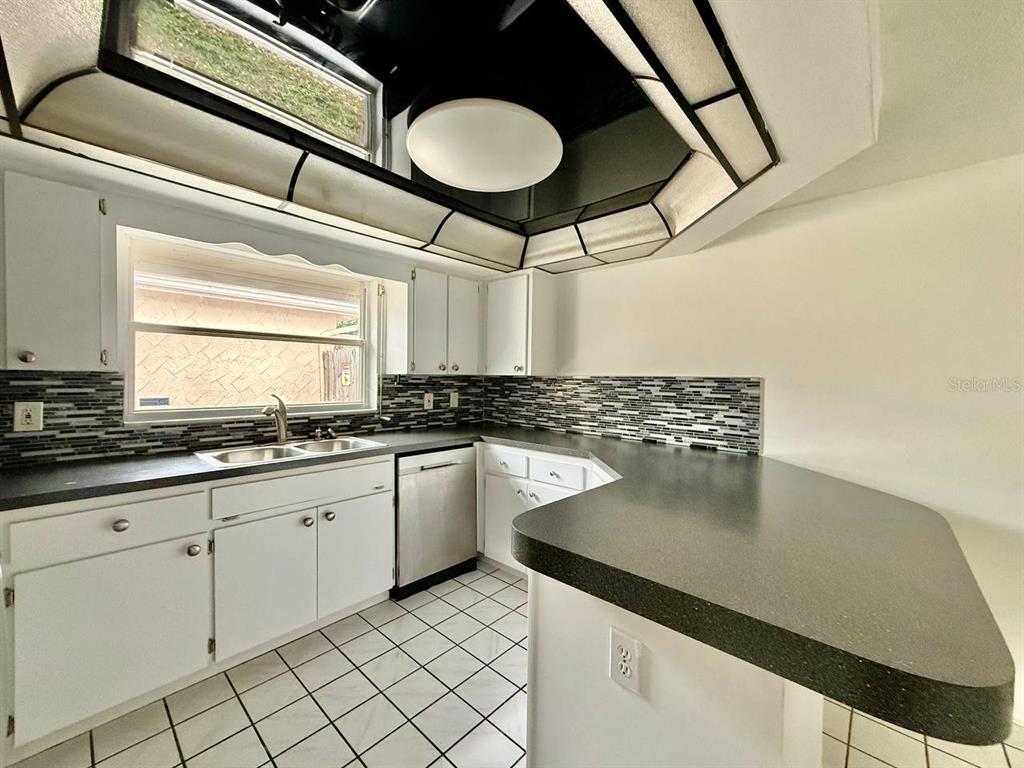 7131 Potomac Drive Port Richey, FL 34668 - Photo 14 of 30 a kitchen with a sink cabinets and window