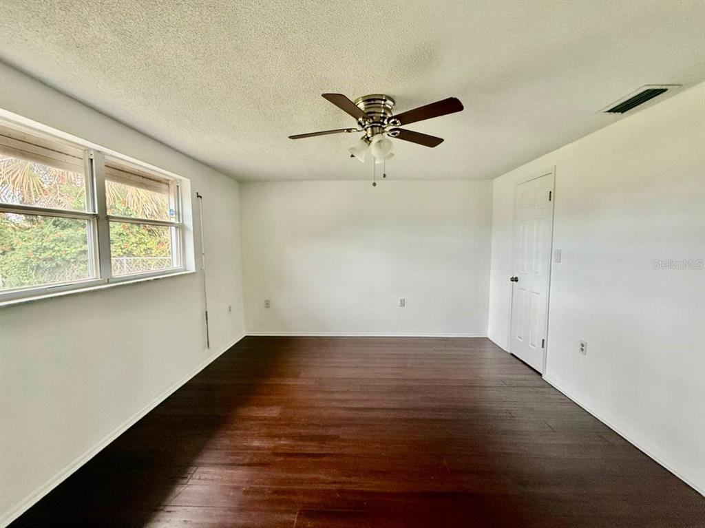 7131 Potomac Drive Port Richey, FL 34668 - Photo 19 of 30 wooden floor in an empty room with a window