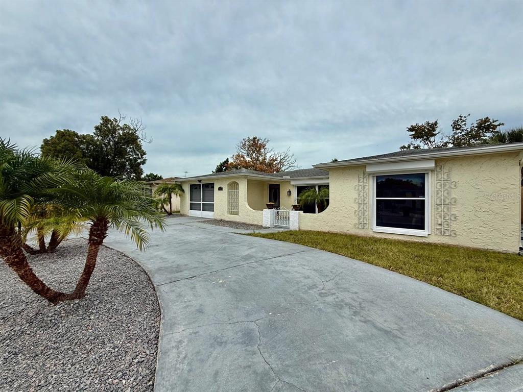7131 Potomac Drive Port Richey, FL 34668 - Photo 2 of 30 a front view of a house with garden