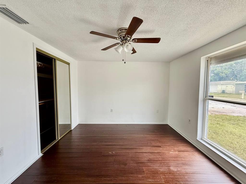 7131 Potomac Drive Port Richey, FL 34668 - Photo 23 of 30 a view of empty room with wooden floor and fan