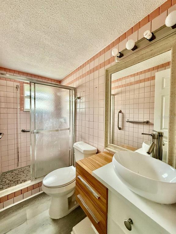 7131 Potomac Drive Port Richey, FL 34668 - Photo 25 of 30 a bathroom with a sink a toilet and shower