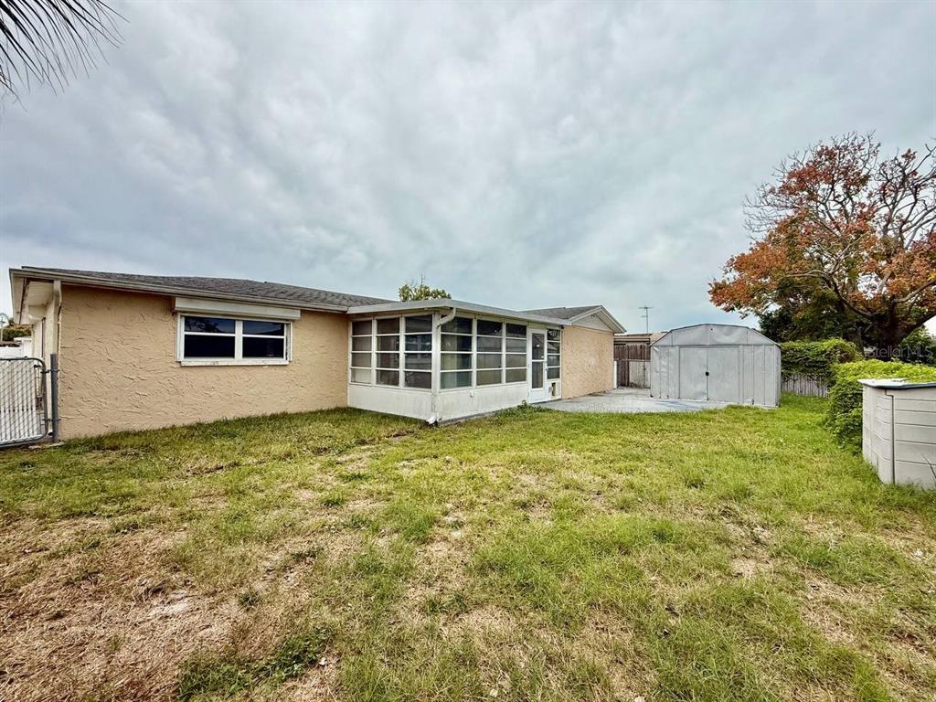 7131 Potomac Drive Port Richey, FL 34668 - Photo 29 of 30 a backyard of a house with large garden and outdoor seating