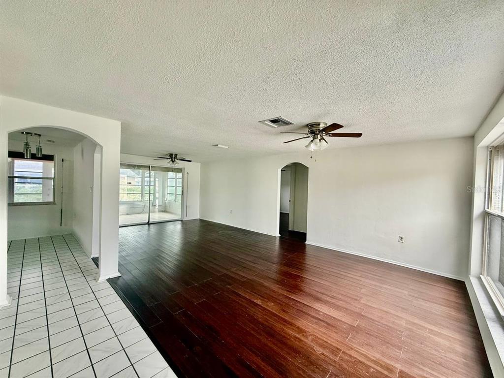 7131 Potomac Drive Port Richey, FL 34668 - Photo 5 of 30 wooden floor in an empty room with a window