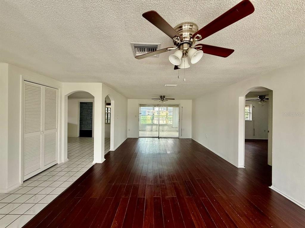 7131 Potomac Drive Port Richey, FL 34668 - Photo 6 of 30 wooden floor in an empty room with a window