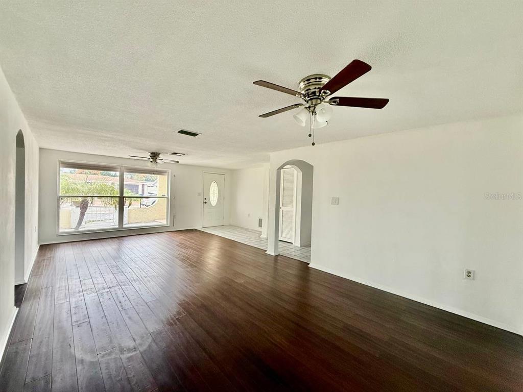 7131 Potomac Drive Port Richey, FL 34668 - Photo 9 of 30 a view of empty room with wooden floor and fan