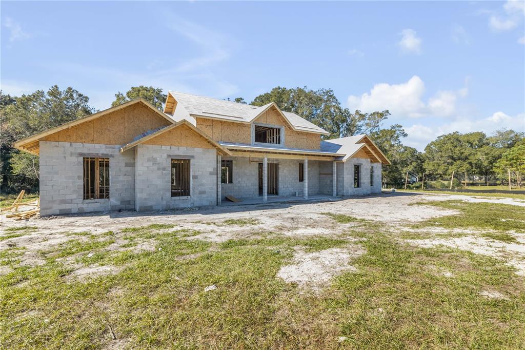 1624 Greens Dairy Road DeLand, FL 32720 - Photo 11 of 51 a front view of a house with a garden and yard