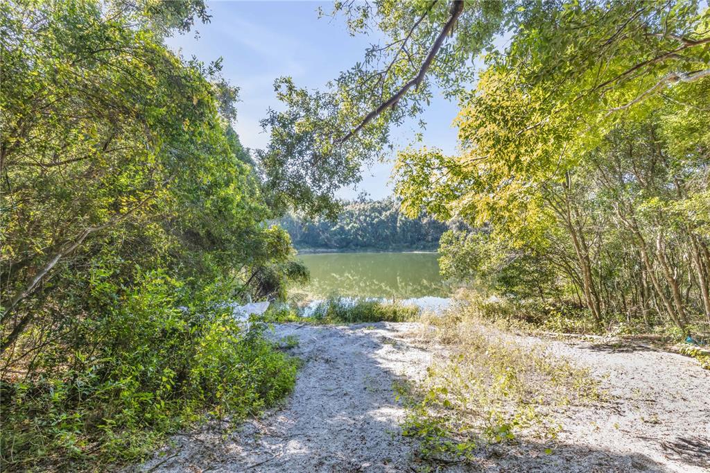 1624 Greens Dairy Road DeLand, FL 32720 - Photo 23 of 51 a view of a lake with a yard and large trees