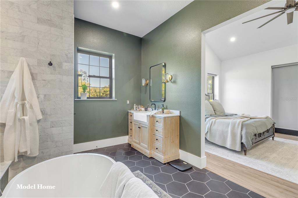 1624 Greens Dairy Road DeLand, FL 32720 - Photo 49 of 51 a spacious bedroom with a bed and a mirror