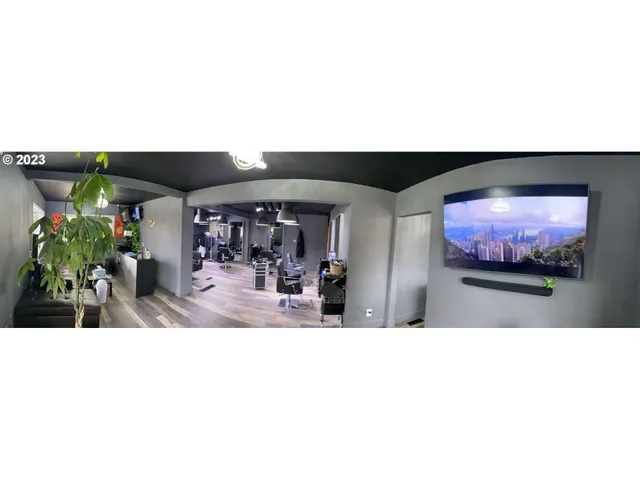 a view of a living room with floor to ceiling windows and a flat screen